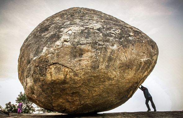 A giant rock between two people