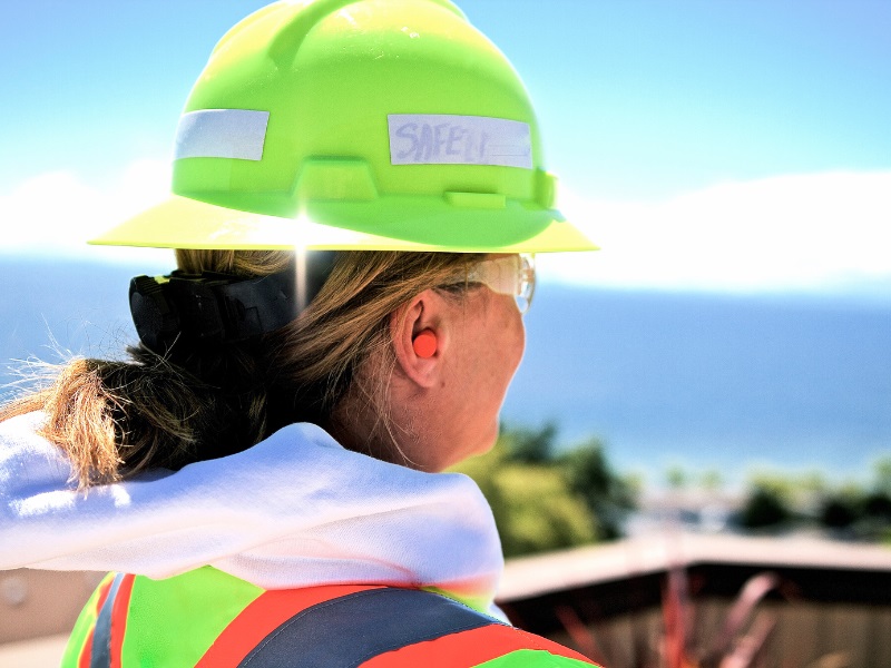 Woman wearing construction gear and earplugs