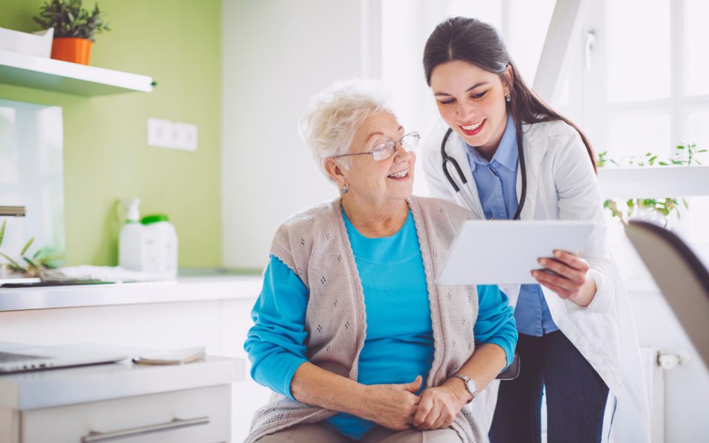 Female doctor showing a chart to an older woman